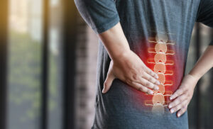 young man Feeling suffering Lower back pain Pain relief concept